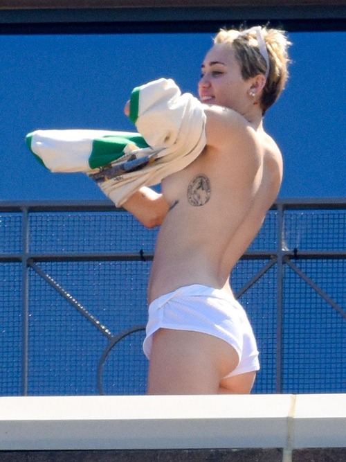 Miley Cyrus - topless on a hotel balcony
