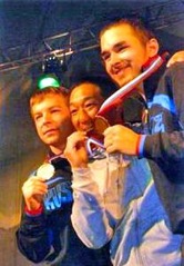 優勝を喜び、金メダルをかむ奥田和夫さん(写真中央)=ロシア・モスクワ