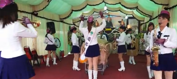 明るい葬式：女子マーチングバンドが個人の棺のまわりを行進する台湾のお葬式
