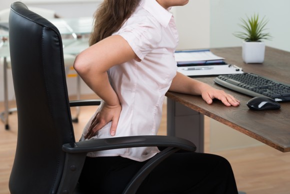 パソコン作業で座りっぱなしの仕事でも正しく座ることで体の負担を減らすことができる。人間工学的に正しい座り方