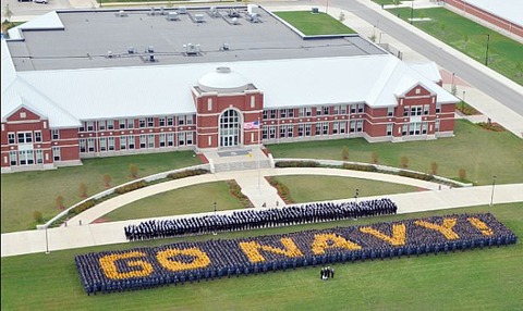 Description: More than 4,750 recruits and staff members from Recruit Training Command spell out Go Navy! in front of the USS Iowa headquarters building at Recruit Training Command. usnavy6