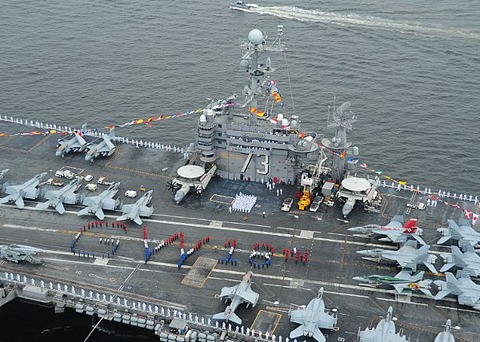Description: Sailors aboard the aircraft carrier USS George Washington (CVN 73) spell out George Washington on the flight deck while arriving in port to commemorate the ship's 18 years of Naval service. usnavy3