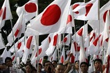 Protesters holding Japanese national flags