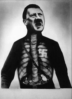John Heartfield「Adolph The Superman」1932-2