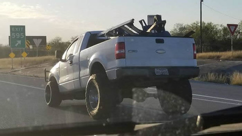 Leaning pickup truck