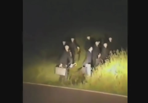 GROUP OF MEN WEARING SUITS RUNNING FROM CAR