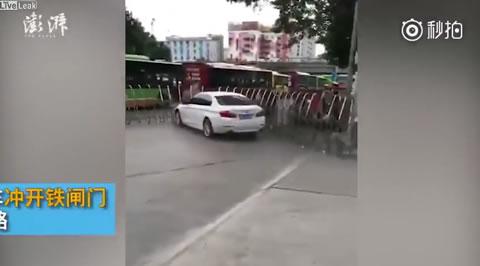 White BMW carries metal gate away to escape inspection