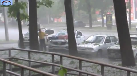 Lady Desperately Tries To Protect Her Car From Hail