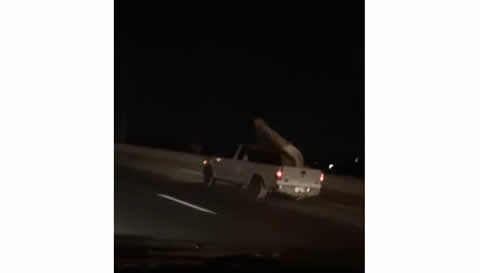 Mattress Flaps in Bed of Truck on Highway