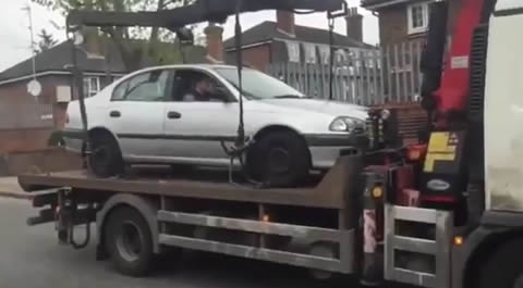 Idiot Tries to Drive His Car off Tow Truck