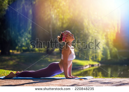 stock-photo-young-woman-doing-yoga-in-morning-park-220848235