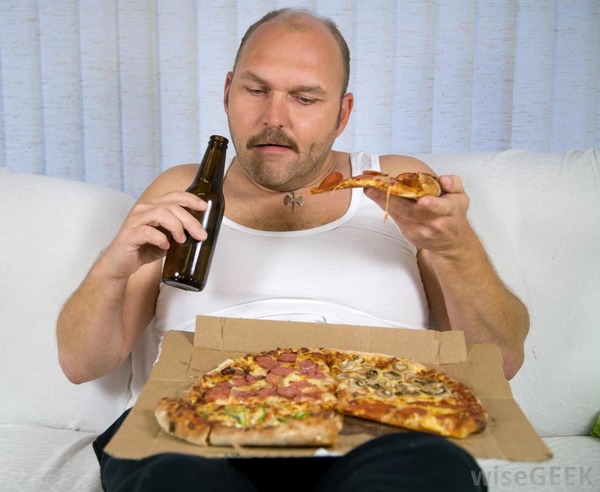 overweight-man-eating-pizza-and-drinking-beer-on-couch