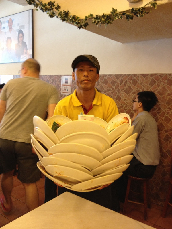 Clearing-plates-level--Asian-waiter-_te7t