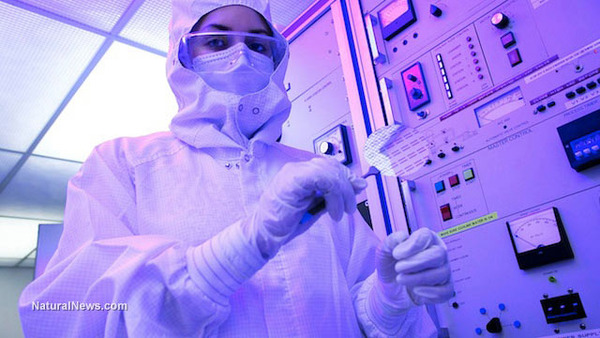 Woman-In-Biohazard-Suit-At-Silicon-Lab-Holding-A-Silicon-Wafer