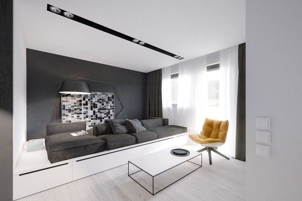 Gian khách được bố trí tối giản với sofa màu ghi và bàn trà cách điệu Gian khách được bố trí tối giản với sofa màu ghi và bàn trà cách điệu