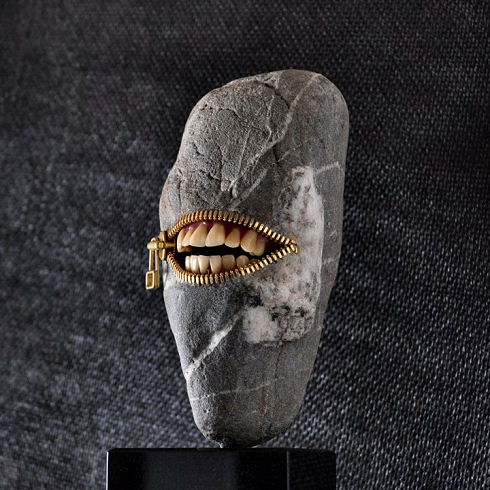 Smiling face sculpted in stone by Hirotoshi Ito