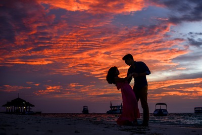 man-and-woman-on-beach-during-sunset-1024963