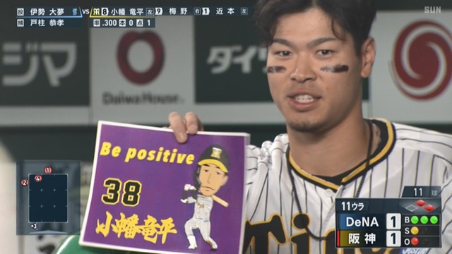 甲子園の一塁ベンチに応援ボードを持った阪神ファンが現れる
