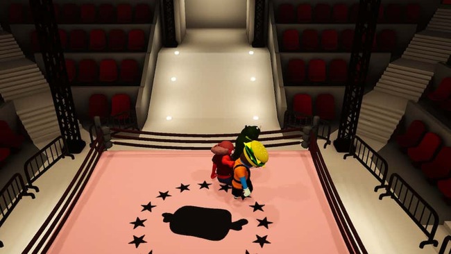 プロレスリングステージでプレイヤーたちが攻防を繰り広げている場面