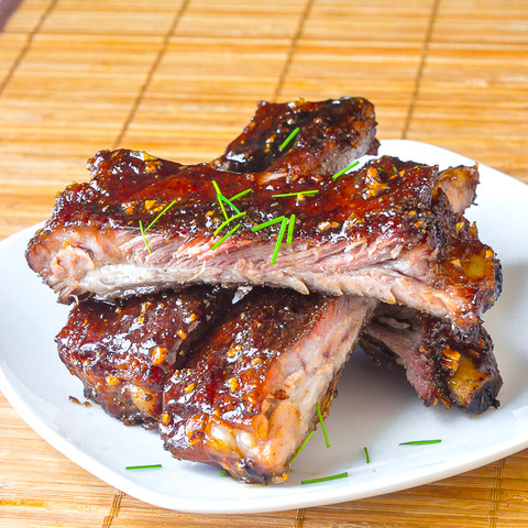 Honey-Garlic-Sticky-Ribs-stacked-on-a-white-plate