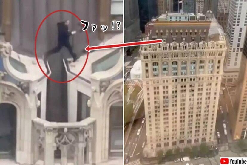 アメリカ高層ビル23階の屋根をスーツ姿で走り移動する男！