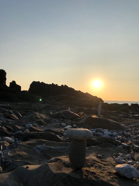 Rock balancing at sunset