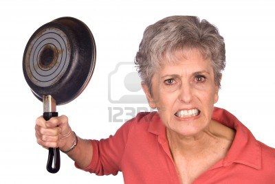 4864102-an-angry-mother-threatens-to-swing-her-frying-pan-is-a-display-of-violent-behavior-image-was-shot-ag[1]