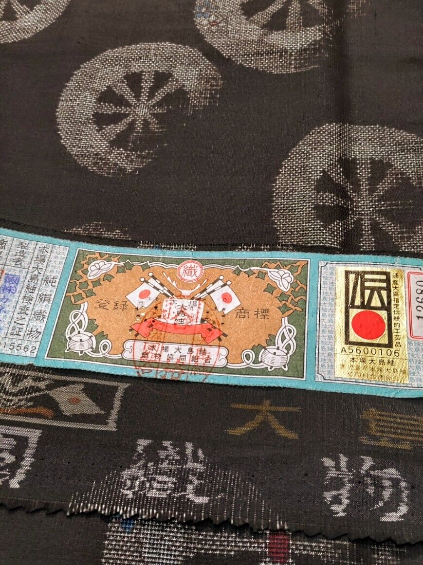 証紙　しつけ付き　本場大島紬　高価地球儀マーク　特別展示会　袋帯　柄合わせ不要 本場大島紬 証紙つき 源氏車柄〜黒兎柄の八寸名古屋帯