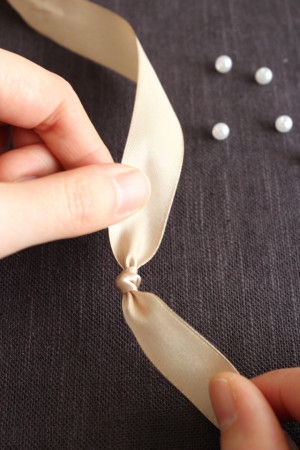 リボンの半分あたりのところに、結び目を1つ作ります。そこを中心に作っていくと左右均等になり、お好みの長を作りやすいです。