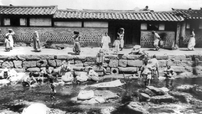 Korean Women washing laundry in stream