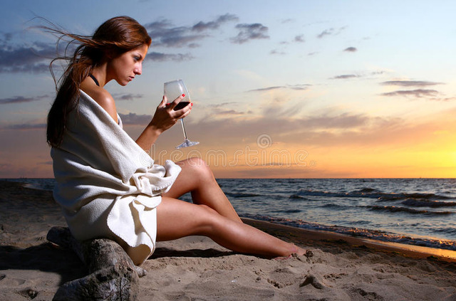 beautiful-young-woman-drinking-wine-beach-10362135