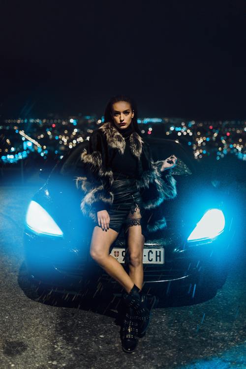 Girl-and-sports-car-under-the-night-Stock-Photo