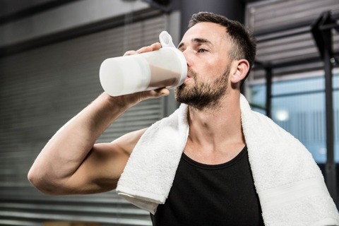 muscular-man-drinking-