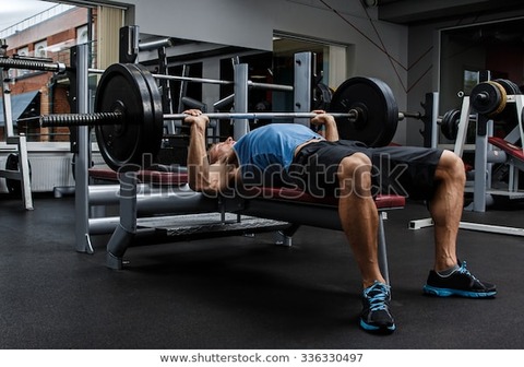 man-during-bench-press-exercise-600w-336330497