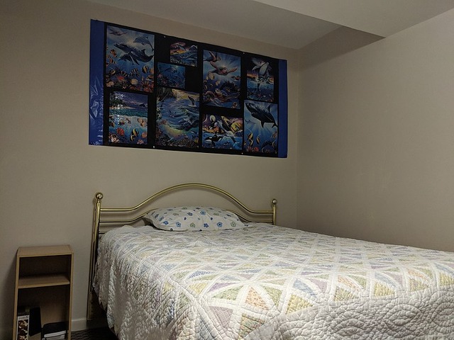Bedroom_with_marine_puzzles_on_wall