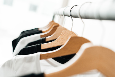 wooden-t-shirt-hangers-in-fashion-apparel-store-2-picjumbo-com