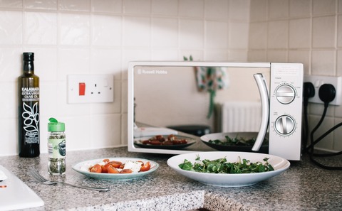 two-white-ceramic-plates-near-microwave-on-counter-top-1287150