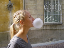 Swiss_woman_blowing_a_bubble_of_gum