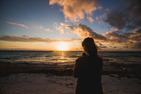 woman-watching-beach-sunrise_925x