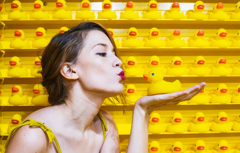 young-woman-blowing-kiss-to-rubber-duck