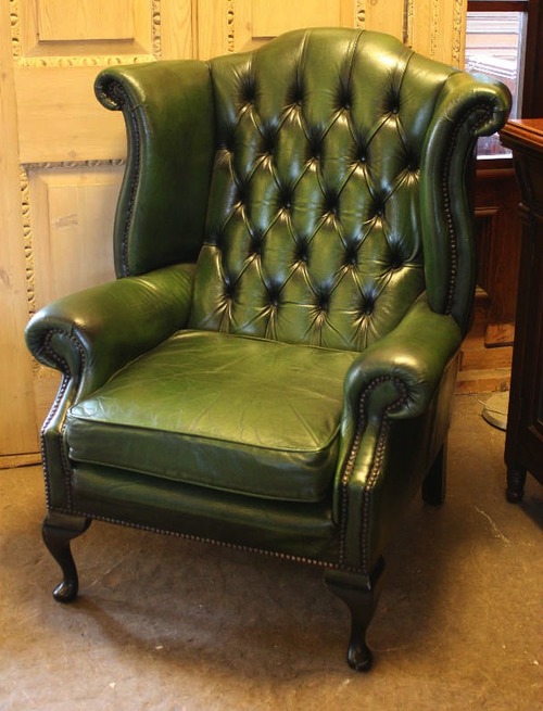 High back green leather wing chair