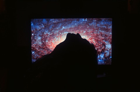 black-flat-screen-tv-turned-on-showing-blue-and-orange-3475378