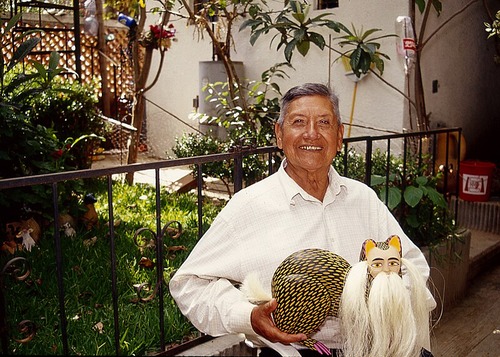 Manuel_Jiménez_Ramírez_holding_nahual_woodcarving