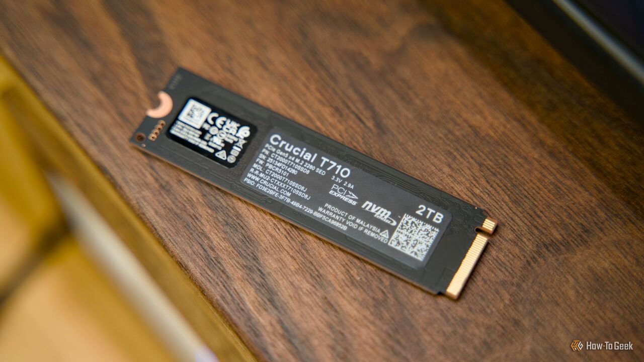 クルミ材の棚の上に置かれた Crucial T710 NVMe SSD の背面。
