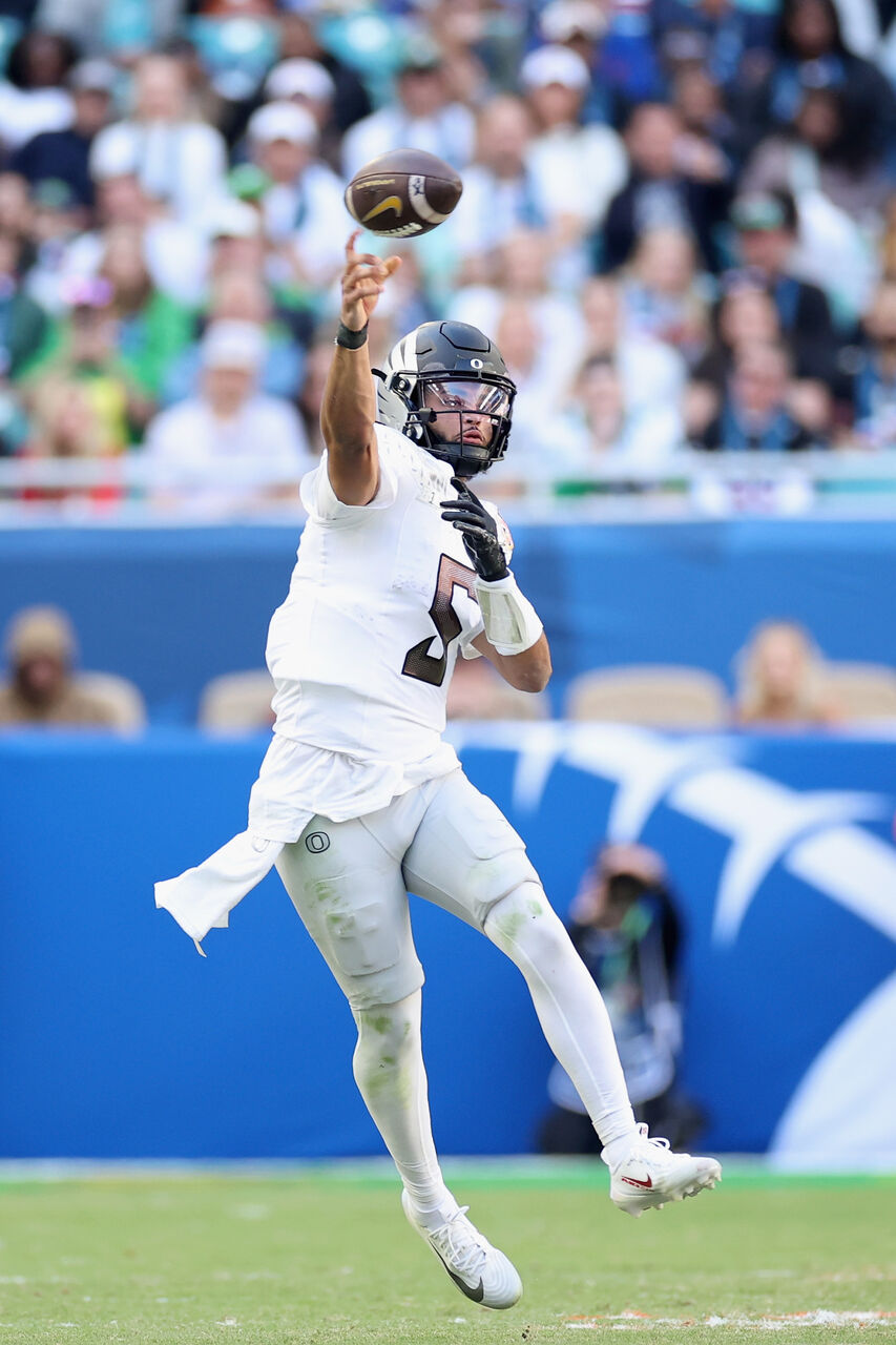 오레곤 덕스의 단테 무어(5번)가 2026년 1월 1일 플로리다주 마이애미 가든스의 하드록 스타디움에서 열린 캐피탈 원 오렌지 보울에서 열린 2025 대학 축구 플레이오프 준준결승 중 2쿼터에서 텍사스 테크 레드 레이더스를 상대로 공을 패스하고 있습니다.