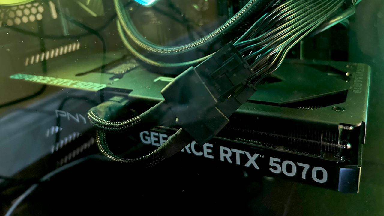 ネオン グリーンのライトで照らされた PC タワー内の GeForce RTX 5070 カード