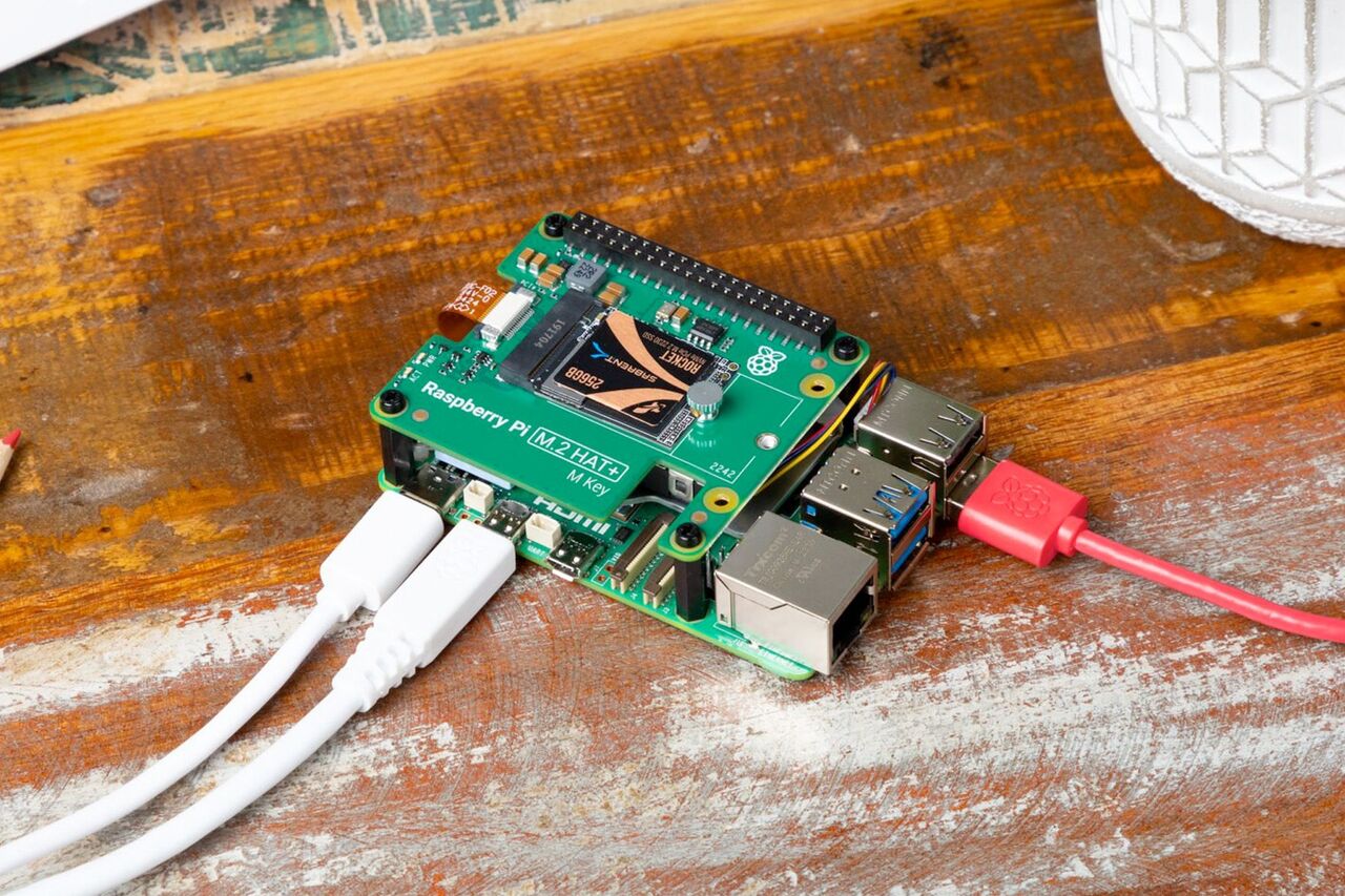 木の表面にケーブルが接続された Raspberry Pi コンピューター。