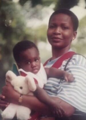 Kpee (Singer) as a baby with his mother