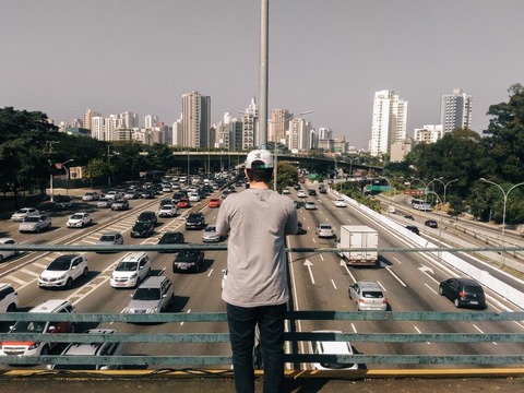 man-overlooks-highway-bridge